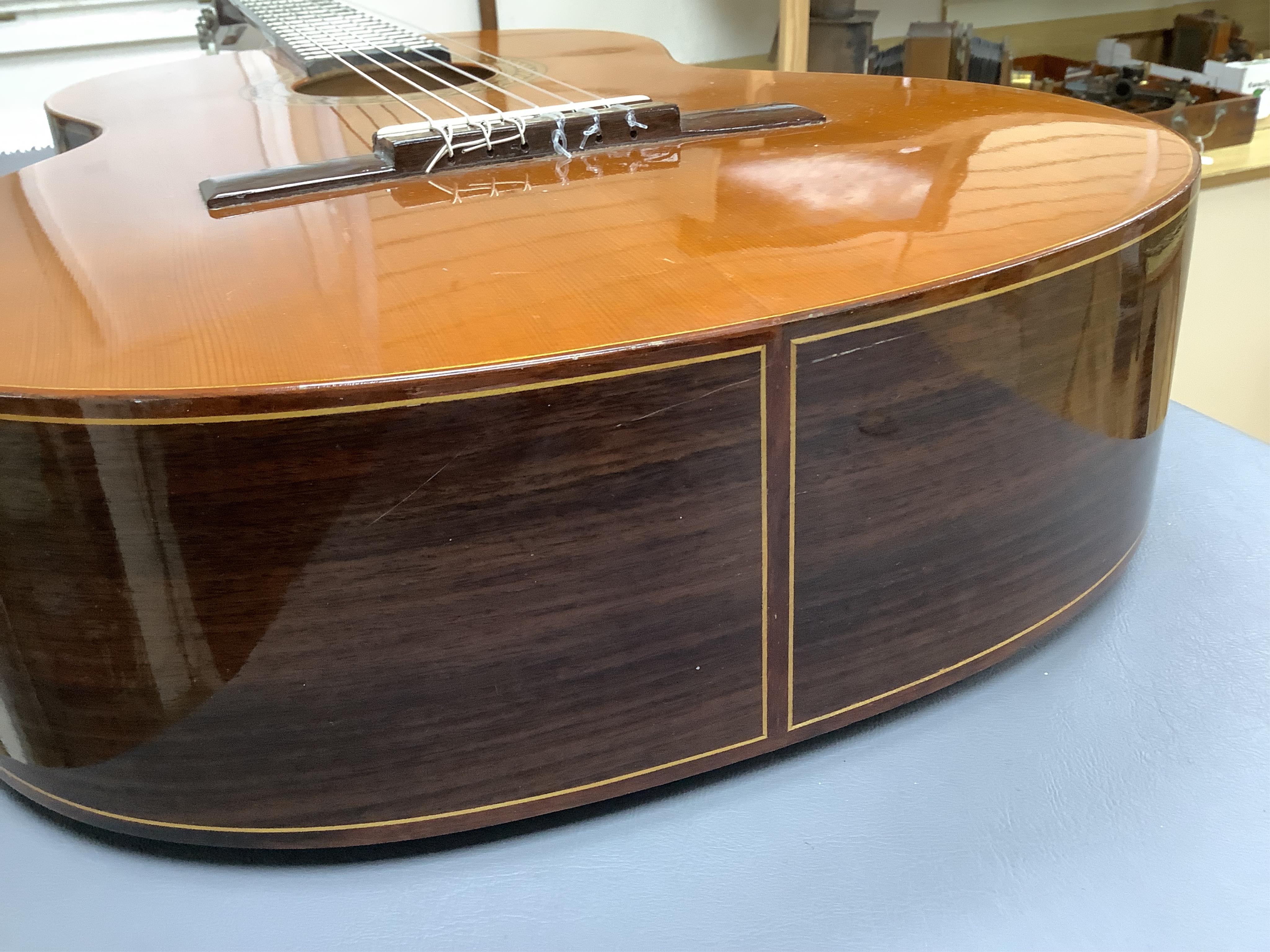 A Spanish Manuel Contreras classical guitar, with cedar front, Indian rosewood back sides and ebony fingerboard, with makers label inside body; M.G. Contreras, Madrid, back 49cm